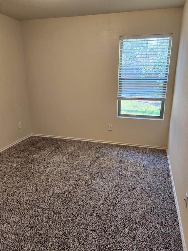 empty room with carpet floors and baseboards