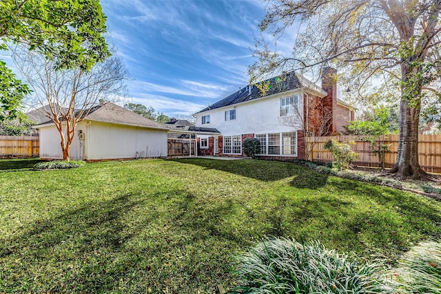 rear view of house with a lawn