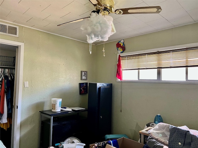 bedroom with ceiling fan and a closet