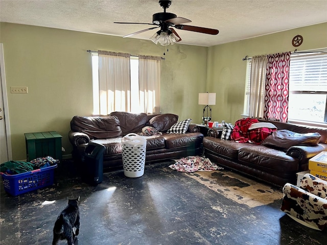 living room featuring ceiling fan and a textured ceiling