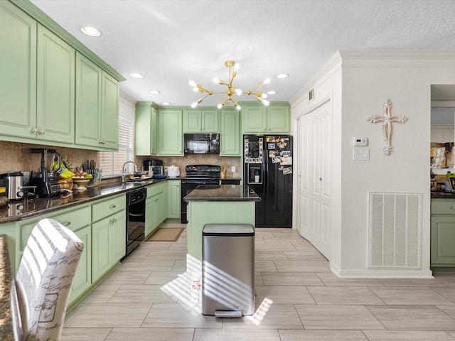 kitchen with sink, green cabinetry, black appliances, a kitchen island, and backsplash