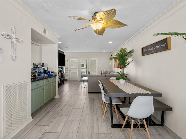 dining room featuring crown molding, a textured ceiling, and ceiling fan