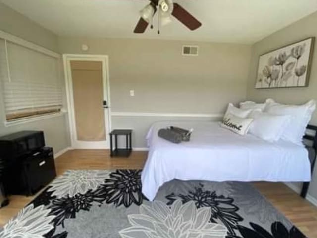 bedroom featuring ceiling fan and wood-type flooring