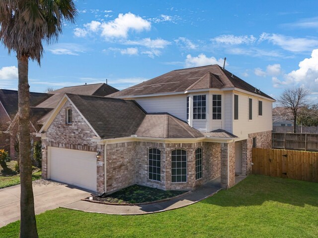 view of front of home with a garage and a front yard