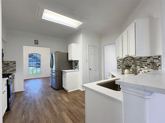 kitchen featuring appliances with stainless steel finishes, dark hardwood / wood-style floors, sink, and white cabinets