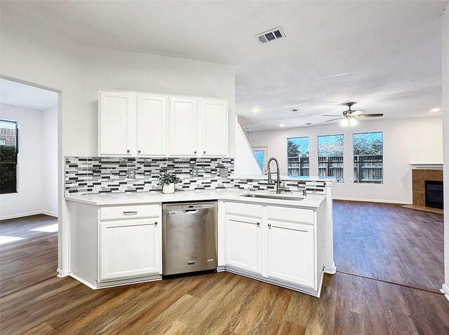 kitchen with dishwasher, sink, white cabinets, and kitchen peninsula