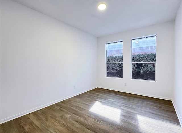 spare room featuring dark hardwood / wood-style floors