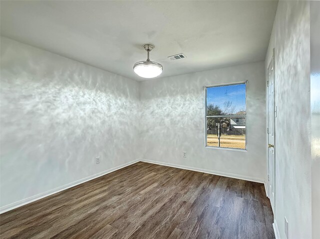 empty room featuring dark hardwood / wood-style flooring