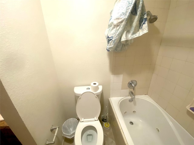 bathroom featuring tiled shower / bath and toilet