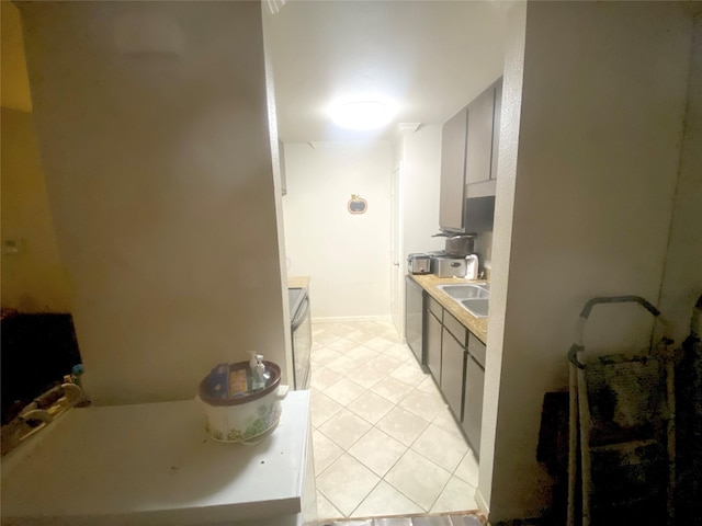 kitchen featuring light tile patterned flooring and sink