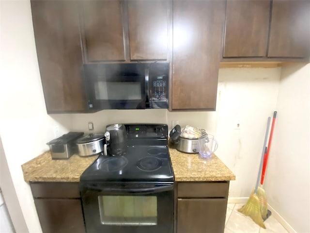 kitchen featuring light stone countertops, light tile patterned floors, dark brown cabinetry, and black appliances