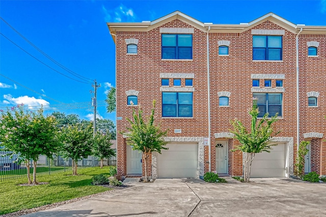 view of property with a garage and a front lawn