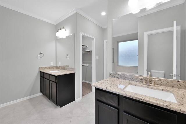 bathroom with vanity, tile patterned flooring, crown molding, and toilet