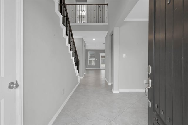 tiled foyer entrance featuring a high ceiling