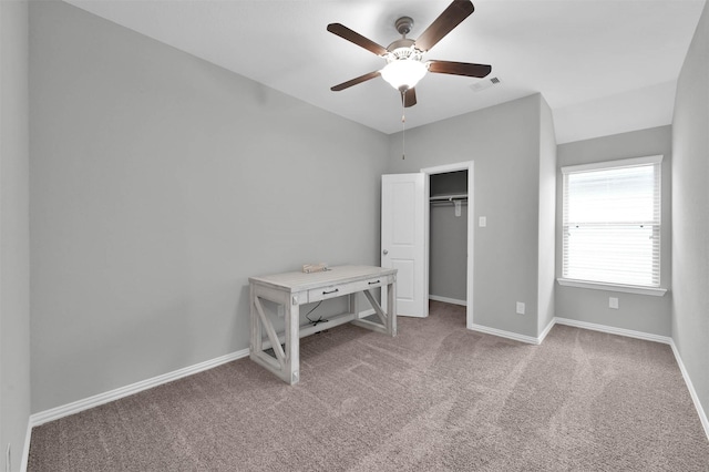 unfurnished bedroom featuring light colored carpet and ceiling fan