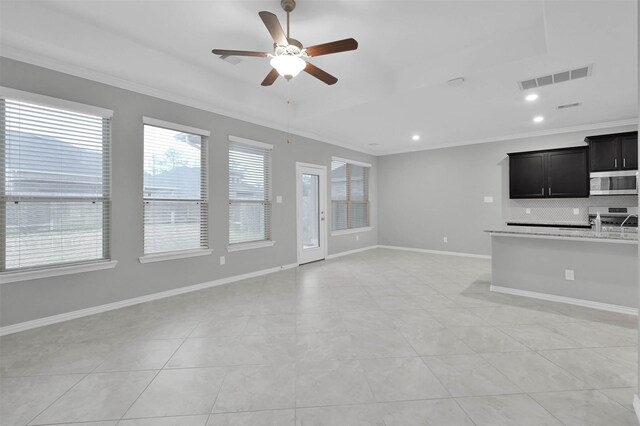 unfurnished living room featuring crown molding, light tile patterned floors, and ceiling fan