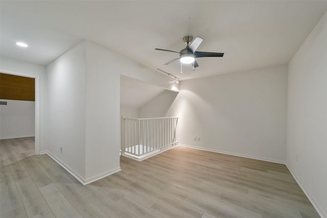 bonus room with ceiling fan and light wood-type flooring