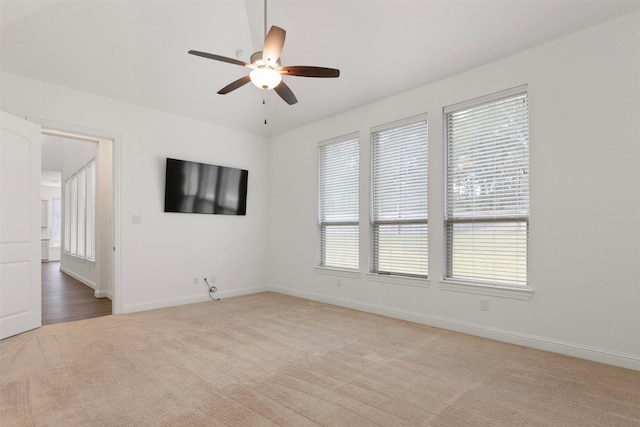 unfurnished room with light carpet and ceiling fan