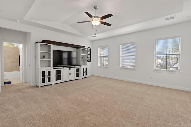 unfurnished living room featuring vaulted ceiling, light carpet, and ceiling fan