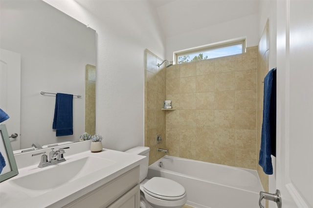 full bathroom with tiled shower / bath, vanity, and toilet