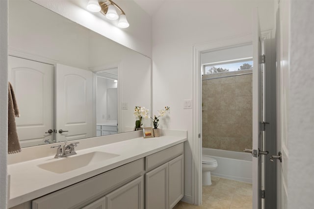 full bathroom with vanity, tiled shower / bath combo, tile patterned floors, and toilet