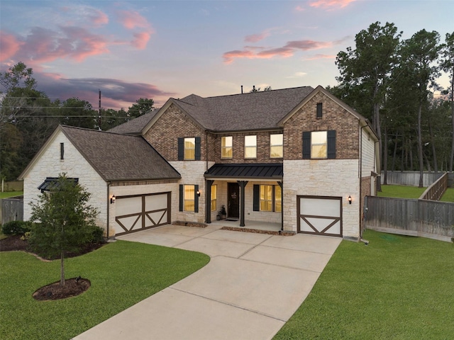 view of front of home featuring a garage, a porch, and a yard