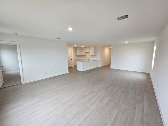 unfurnished living room with light wood-type flooring