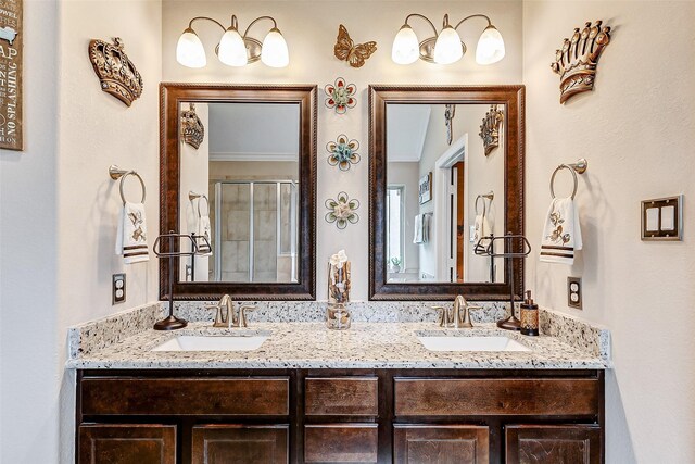 bathroom with a shower with door and vanity