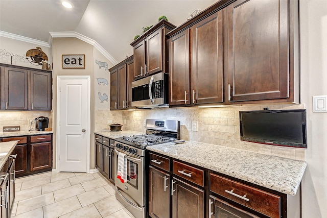 kitchen with lofted ceiling, dark brown cabinetry, ornamental molding, and appliances with stainless steel finishes