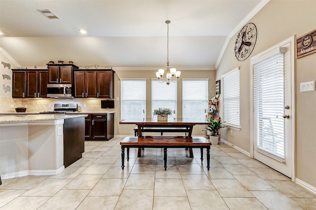 kitchen featuring light tile patterned floors, appliances with stainless steel finishes, hanging light fixtures, dark brown cabinets, and a chandelier