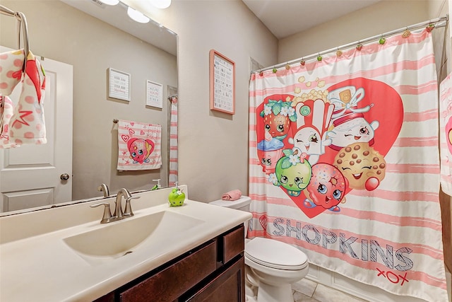 bathroom with vanity, curtained shower, and toilet