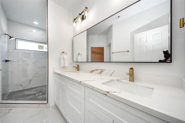 bathroom featuring tiled shower and vanity