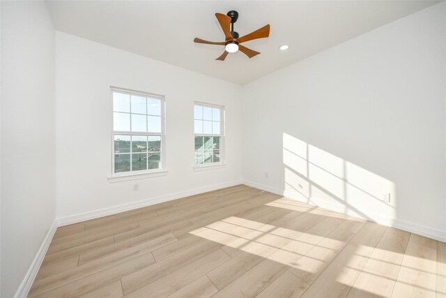 unfurnished room with ceiling fan and light wood-type flooring