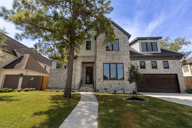 view of front of house featuring a garage and a front lawn