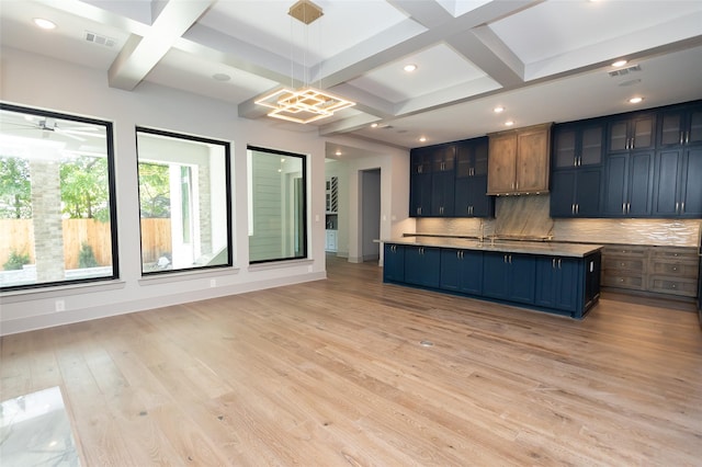 kitchen featuring tasteful backsplash, blue cabinets, hanging light fixtures, coffered ceiling, and light wood-type flooring