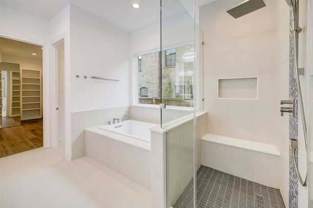 bathroom featuring shower with separate bathtub