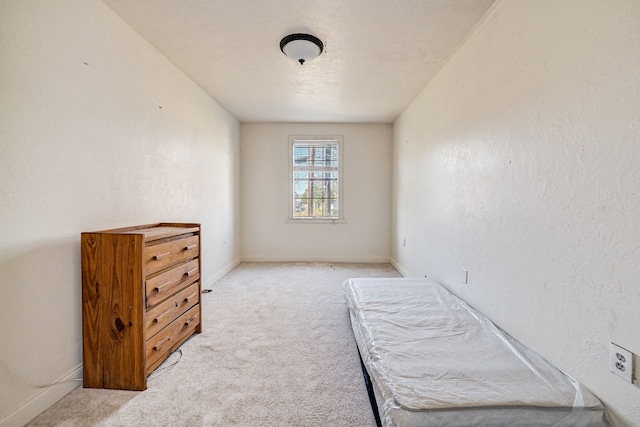 bedroom featuring light carpet