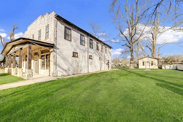 exterior space with an outbuilding and a lawn