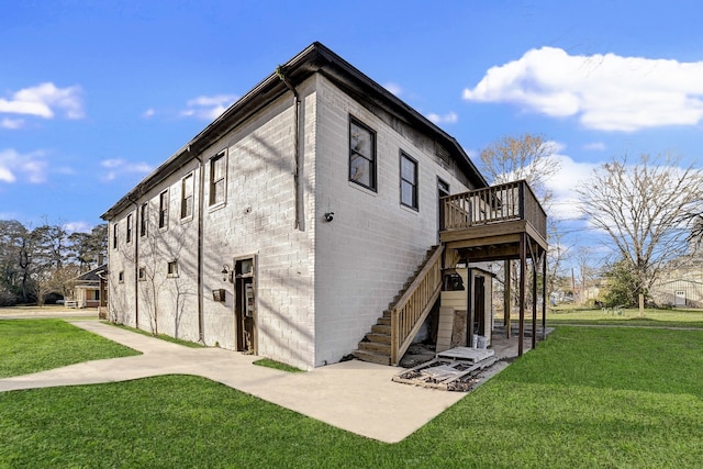 exterior space featuring a wooden deck, a yard, and a patio