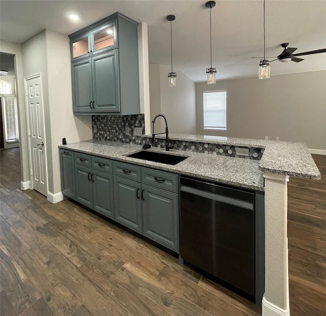 kitchen with sink, black dishwasher, tasteful backsplash, light stone countertops, and dark hardwood / wood-style flooring