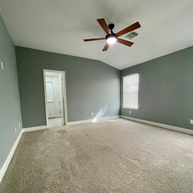 carpeted empty room featuring lofted ceiling and ceiling fan