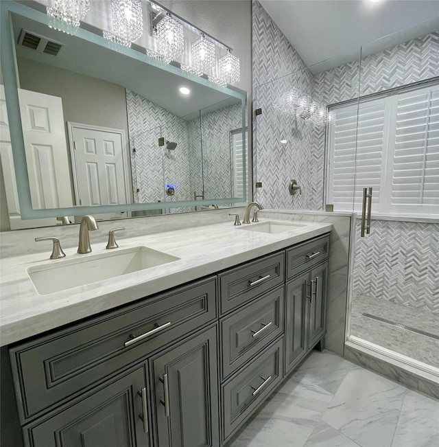 bathroom with vanity, an enclosed shower, and tile walls