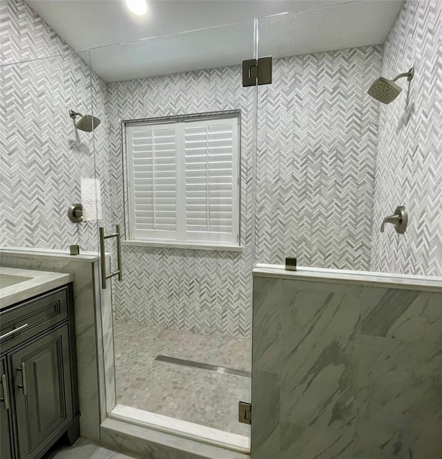 bathroom with vanity and a shower with shower door