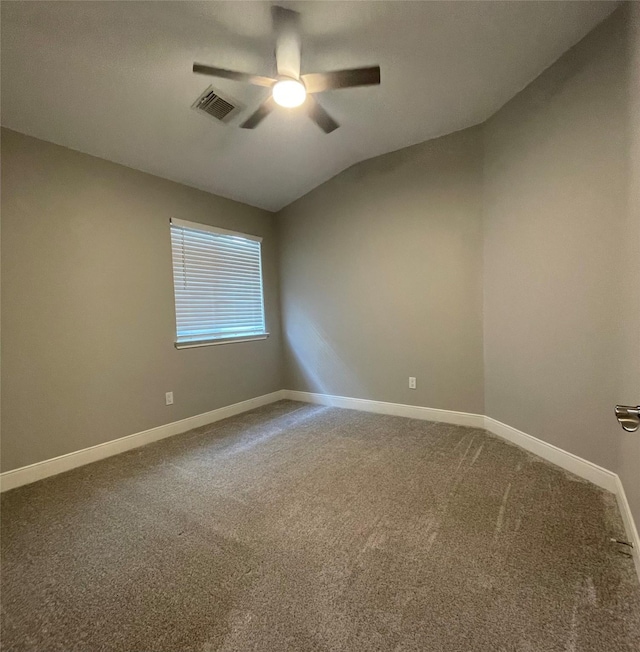 unfurnished room with vaulted ceiling, ceiling fan, and carpet flooring