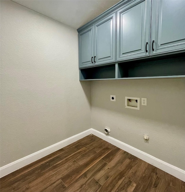 laundry room with dark wood-type flooring, cabinets, hookup for a washing machine, hookup for an electric dryer, and hookup for a gas dryer