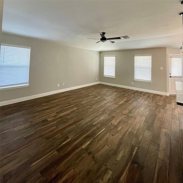 unfurnished room featuring ceiling fan and dark hardwood / wood-style flooring