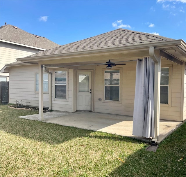 rear view of house featuring a yard, ceiling fan, and a patio area