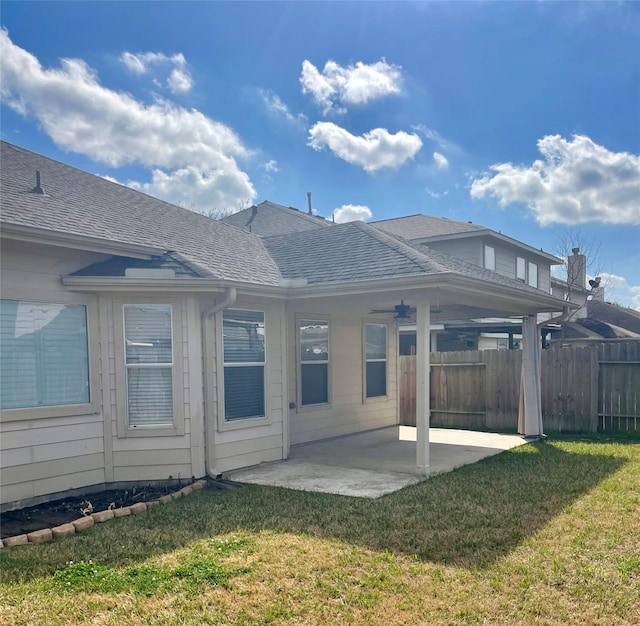 rear view of property featuring a patio and a lawn