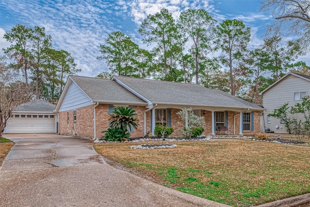 view of front of home featuring a porch, a garage, an outdoor structure, and a front yard