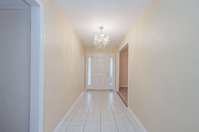 entryway featuring light tile patterned floors and a notable chandelier